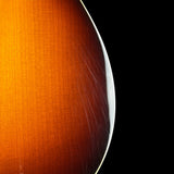 Close-up of a glossy, warm orange-brown wood surface with visible grain and a curved white edge against a solid black background.