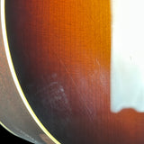 Close-up of a glossy brown wooden surface with visible wood grain, a light-colored edge, and a bright white highlight from reflected light.