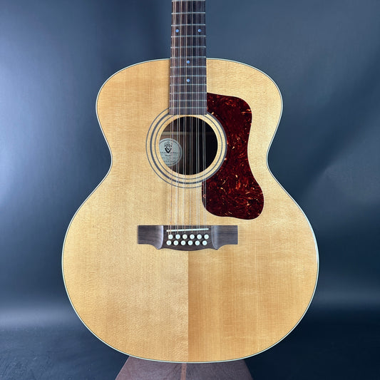 Acoustic guitar with a wooden finish on a dark blue background
