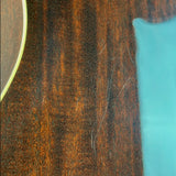 Close-up of a dark brown wood grain surface with a bright turquoise-blue area on the right and part of a circular brown object visible on the left edge.