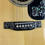 Close-up of an acoustic guitar's soundhole with decorative inlay