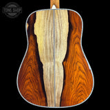Close-up of a guitar's back with a visible brand logo in the corner.