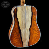 Close-up of a guitar's back with a visible brand logo in the corner.