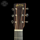 Guitar headstock with Martin & Co logo on a black background