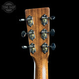 Close-up of a guitar headstock with tuning pegs on a black background, featuring the Tone Shop logo.