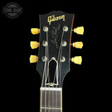 Gibson Les Paul guitar headstock with tuning pegs on a black background