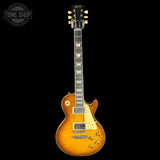 Gibson electric guitar with a sunburst finish on a black background
