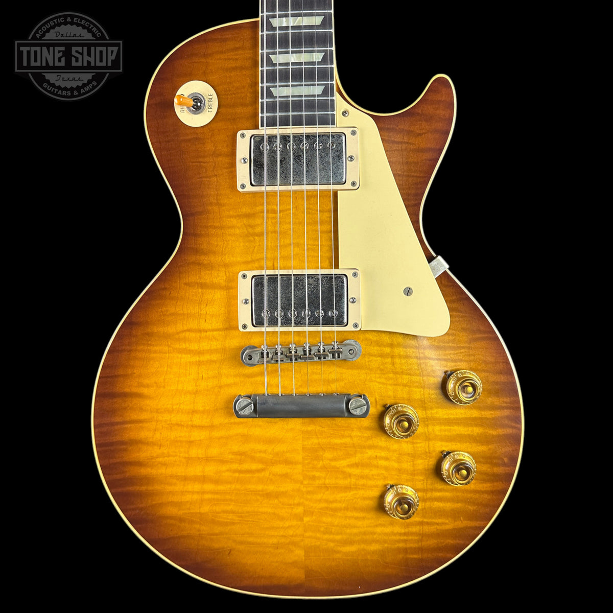 Electric guitar with a sunburst finish on a black background, featuring the Tone Shop logo.