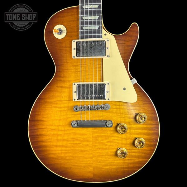 Electric guitar with a sunburst finish on a black background, featuring the Tone Shop logo.