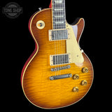 Electric guitar with a sunburst finish on a black background, featuring the Tone Shop logo.