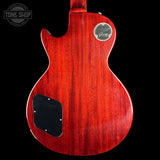 Red electric guitar body with Gibson logo on a black background