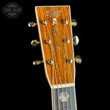 Close-up of a guitar headstock with brand name on a black background