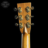 Close-up of a guitar headstock with tuning pegs on a black background, featuring the Tone Shop logo.