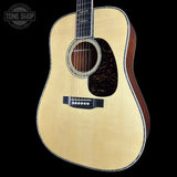 Acoustic guitar with a visible brand logo in the corner