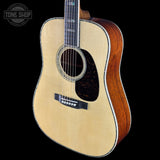 Acoustic guitar with a visible brand logo on a black background