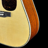 Close-up of a acoustic guitar with a focus on the wood finish.