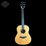 Acoustic guitar with a visible brand logo on a black background