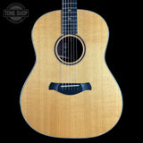 Acoustic guitar with a visible brand logo on a black background