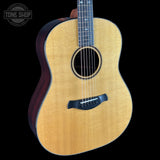 Acoustic guitar with a visible brand logo on a black background