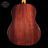Back view of a wooden acoustic guitar with 'Tone Shop' branding.