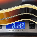 Vintage 1972 Gretsch Super Chet Sunburst on scale displaying weight.