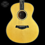 Acoustic guitar with a visible brand logo on a black background