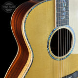 Close-up of an acoustic guitar with a visible brand logo in the corner.