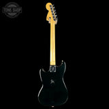 Black electric guitar with a maple neck on a white background, featuring the Tone Shop logo.