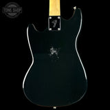 Black electric guitar body with a visible brand logo on a black background