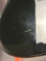 Close-up of a black surface with visible scratches and smudges.