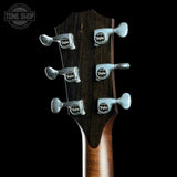 Guitar headstock with tuning pegs on a black background, featuring the Taylor logo.