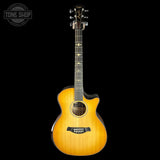 Acoustic guitar with a sunburst finish on a black background, featuring the Taylor logo.