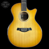 Acoustic guitar with a visible brand logo on a black background