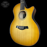 Acoustic guitar with a visible brand logo on a black background
