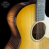 Close-up of an acoustic guitar with a visible brand logo in the corner.