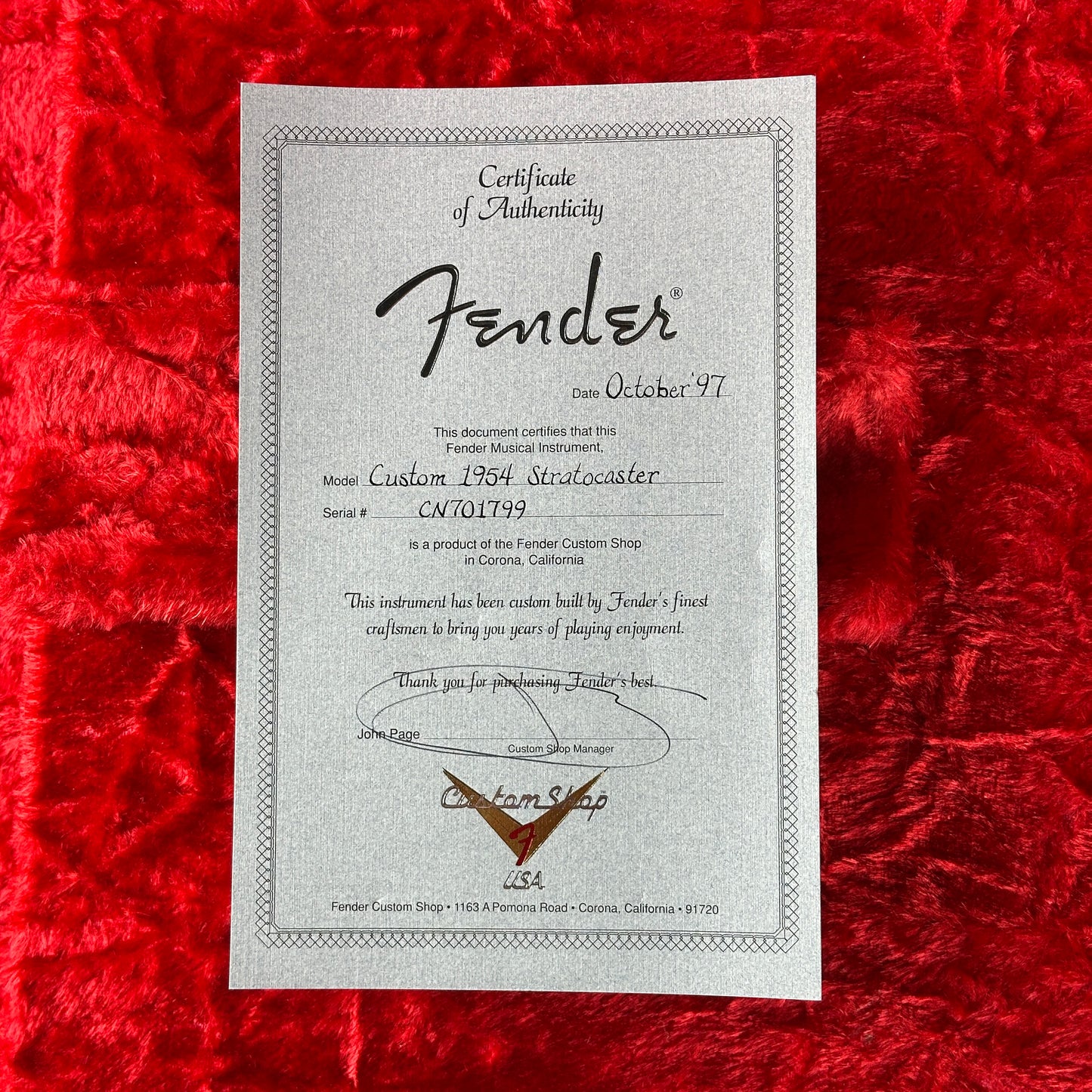 Fender certificate of authenticity on a red textured background