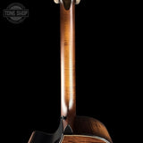 Close-up of a guitar neck with a dark background