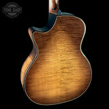 Close-up of a wooden acoustic guitar body with 'Tone Shop' logo in the corner.