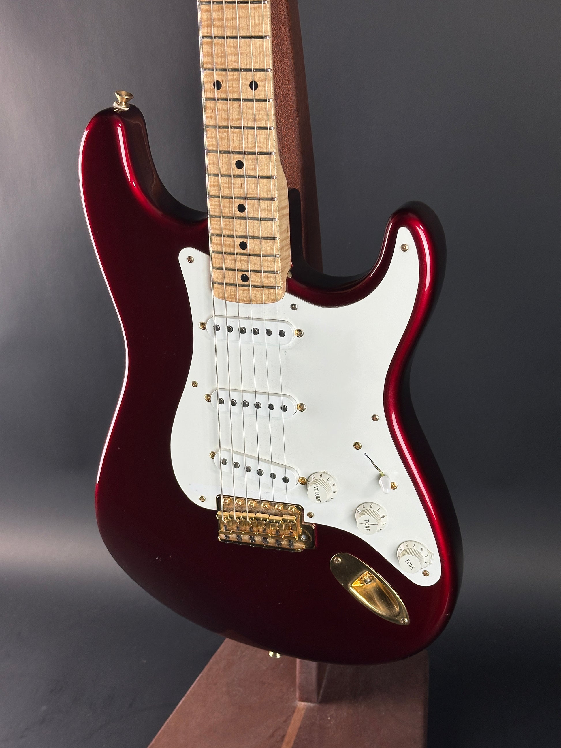 Electric guitar with a red and white design on a gray background