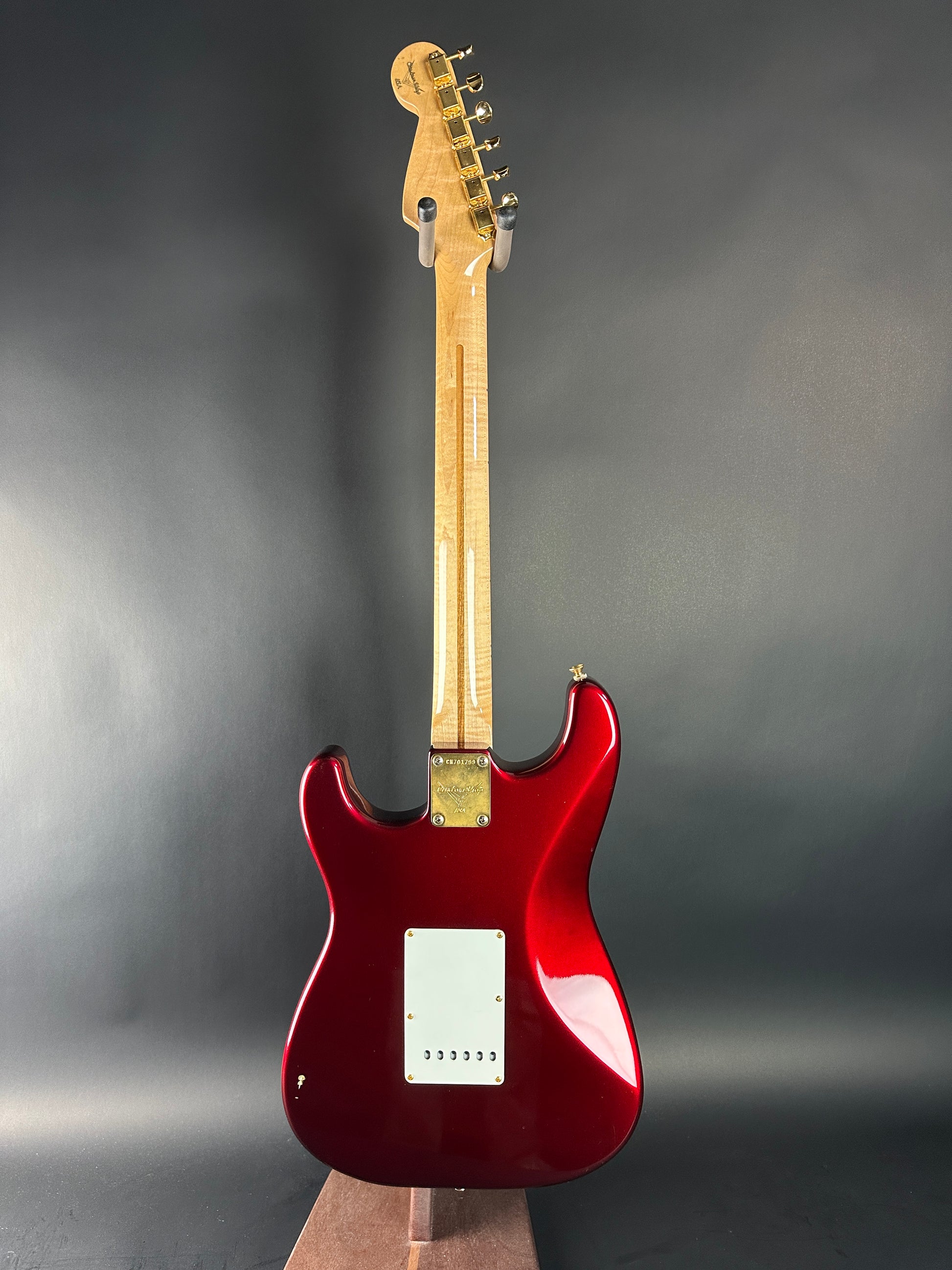 Red electric guitar on a gray background