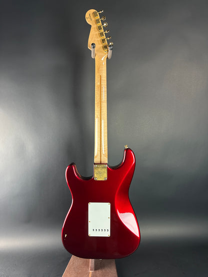 Red electric guitar on a gray background