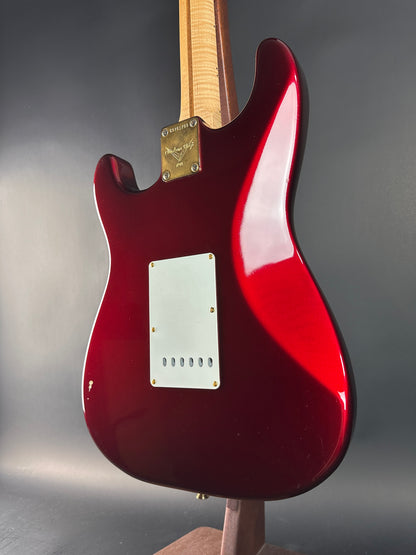 Red electric guitar on a gray background