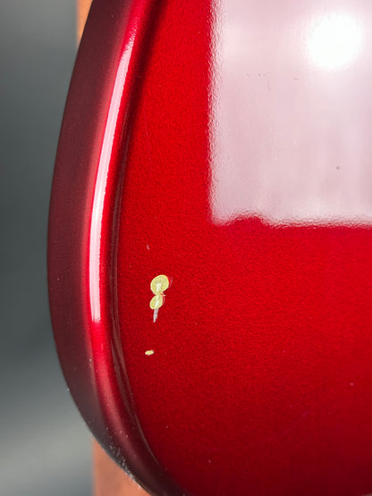 Close-up of a red surface with a small yellow object on it