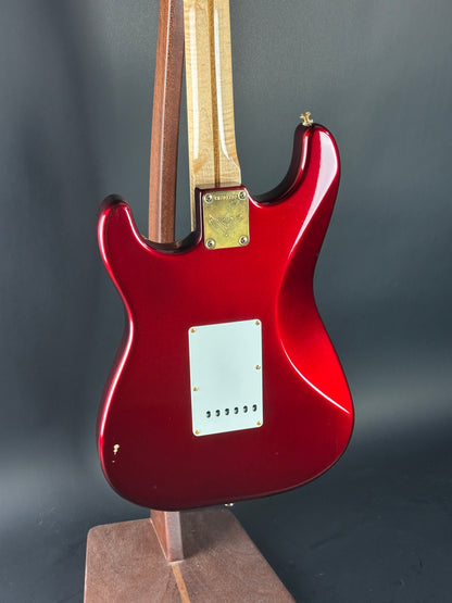 Red electric guitar on a dark gray background