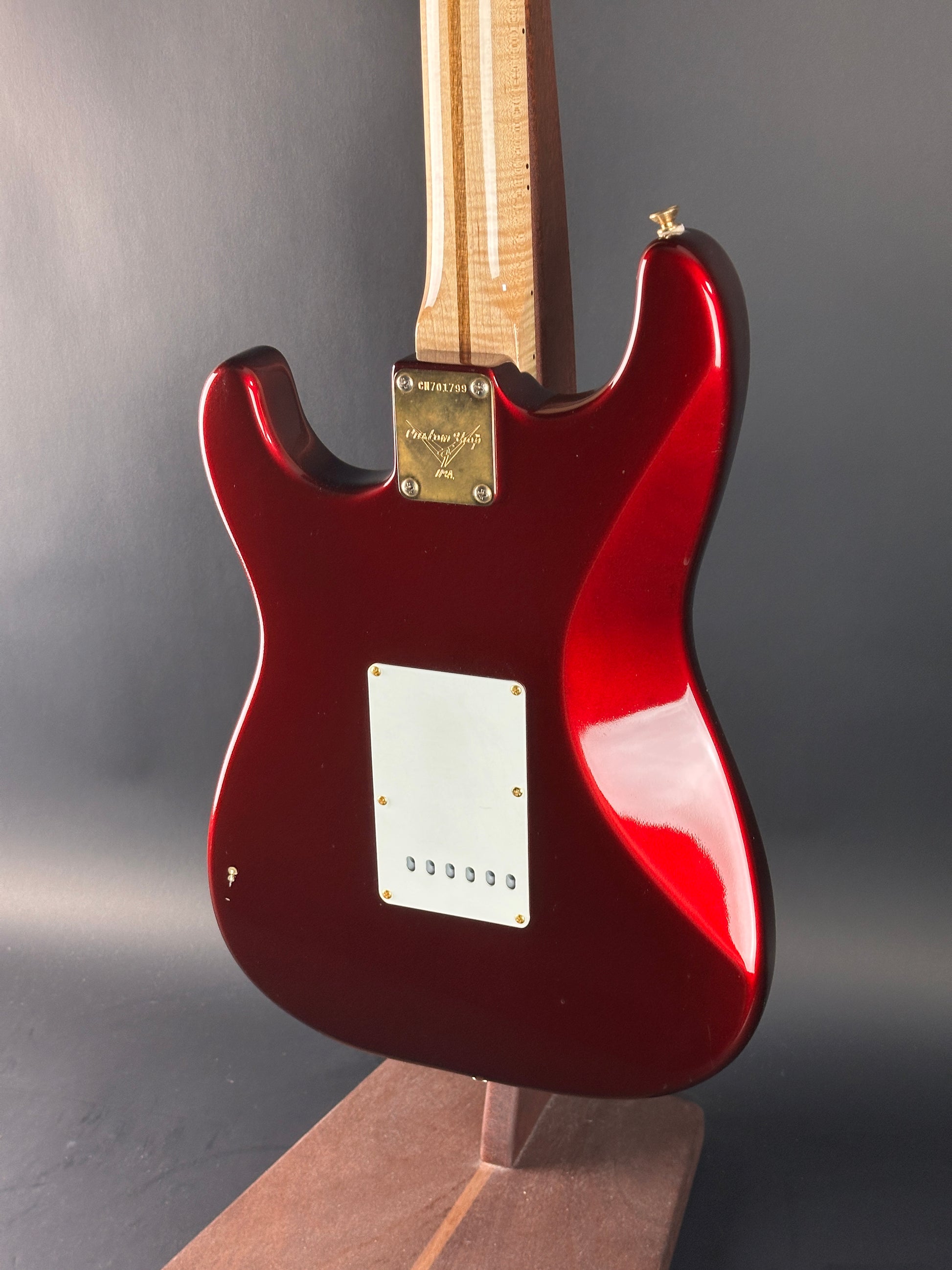 Red electric guitar on a gray background