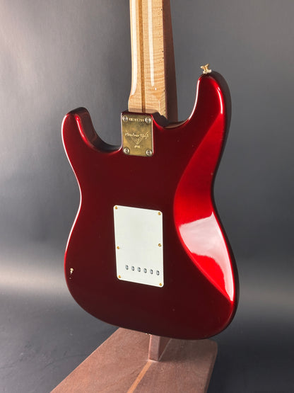 Red electric guitar on a gray background