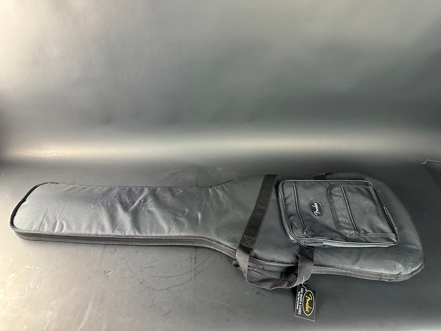 Gray guitar case on a reflective gray surface