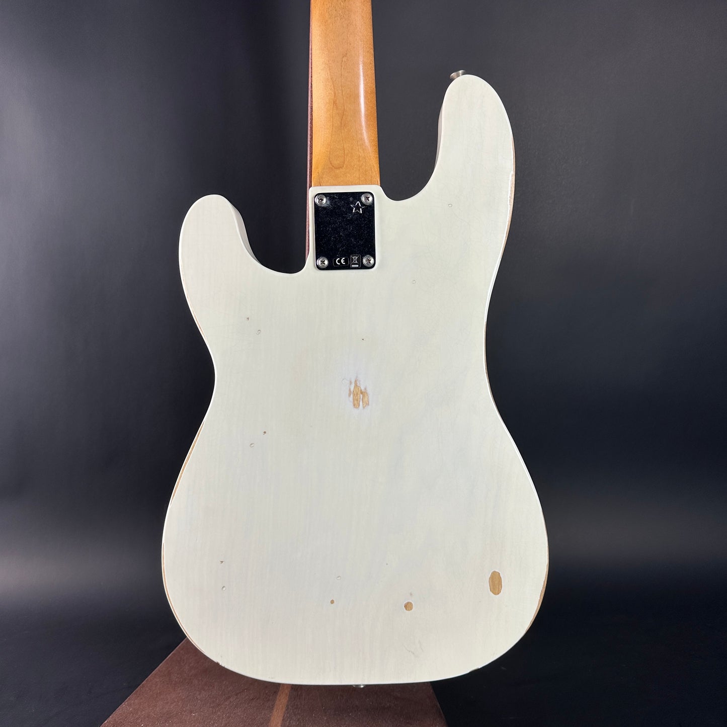 White electric guitar body with a dark background