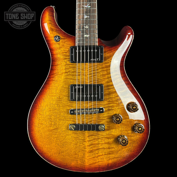 Electric guitar with a sunburst finish on a black background, featuring the Tone Shop logo.