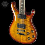 Electric guitar with a sunburst finish on a black background, featuring the Tone Shop logo.